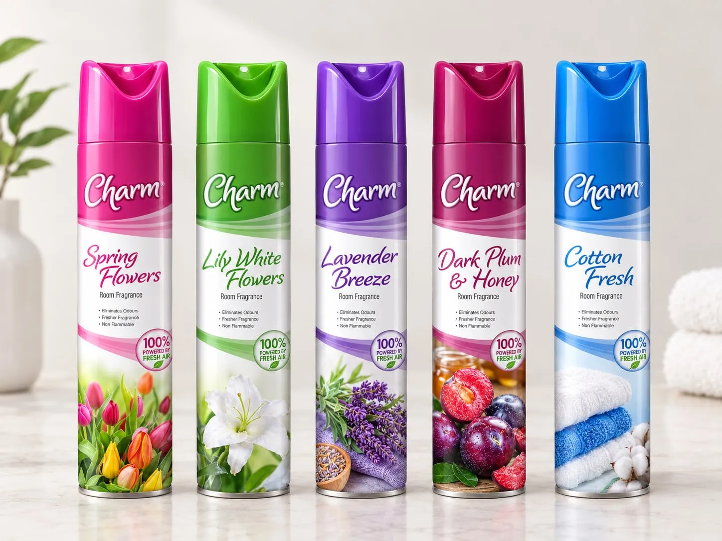 Five Charm room fragrance aerosols: Spring Flowers, Lily White Flowers, Lavender Breeze, Dark Plum and Honey, and Cotton Fresh.